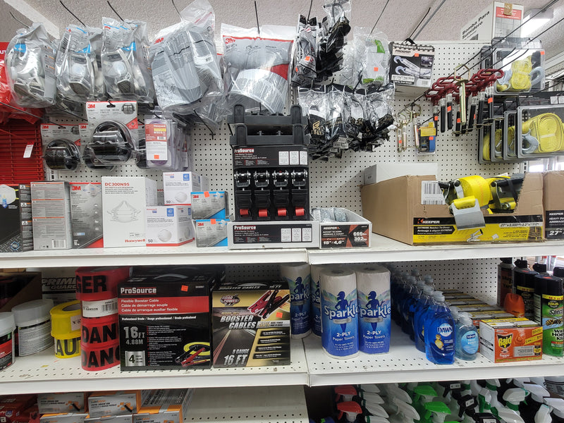 A variety of respirators and face masks, booster cables, caution tape, paper towels, dish soap, hand soap, and ratchet straps.