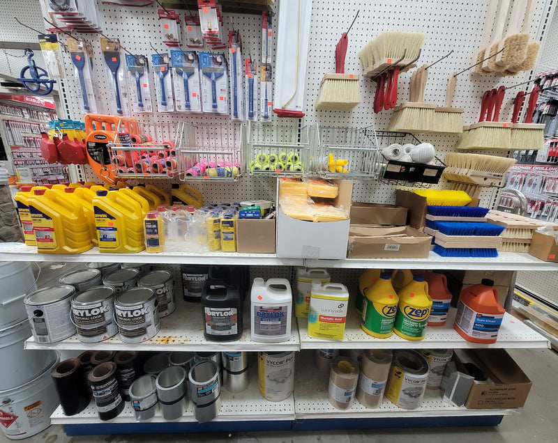 A shelf filled with Irwin Strait-Line Chalk, Keson Giant Chalk Wheels, Floor Chisels, Brick Sets, Utility Brushes, Driveway Sealer, and Driveway Cleaners.